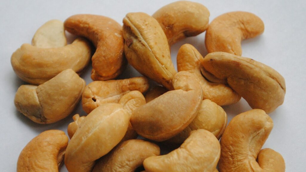 Cashew nuts on plain white tabletop