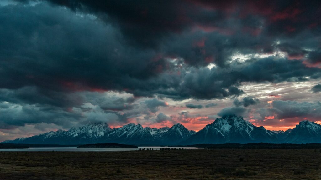 Sky with storm clouds looming above mountain scenery