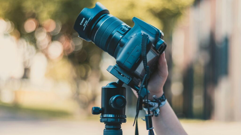 Photographer mounting DSLR camera on tripod