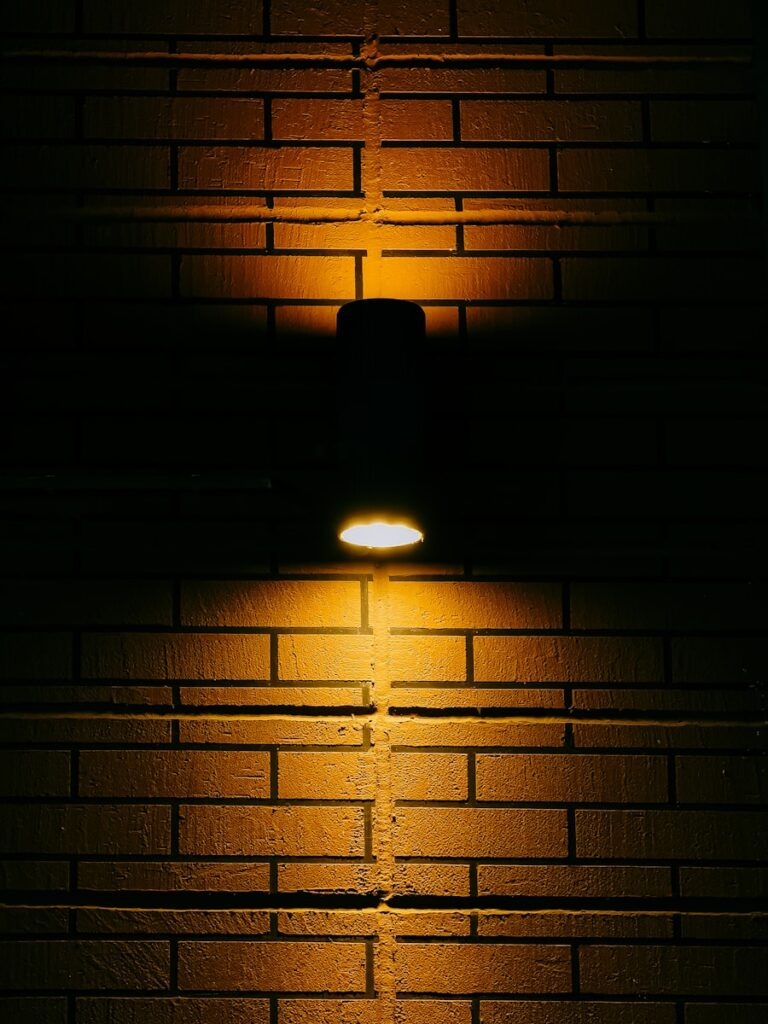Soft yellow light illuminating dark wall