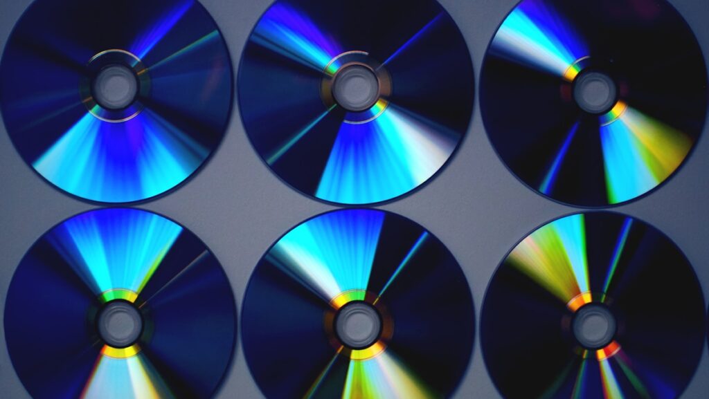 Six CD discs arranged in a neat row