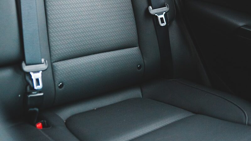 Black leather car seat with seatbelt