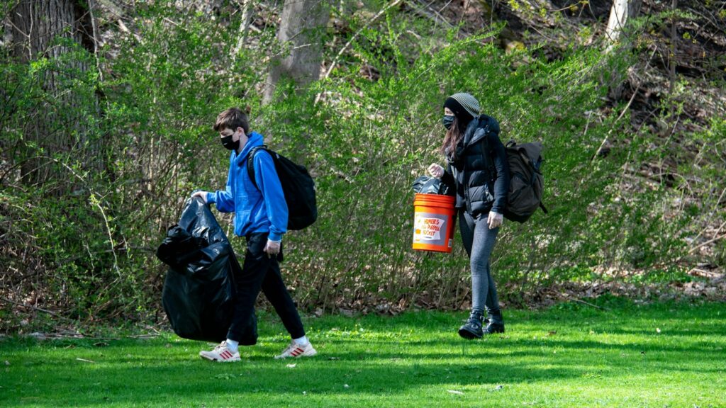 Two volunteers picking up litter during a community cleanup