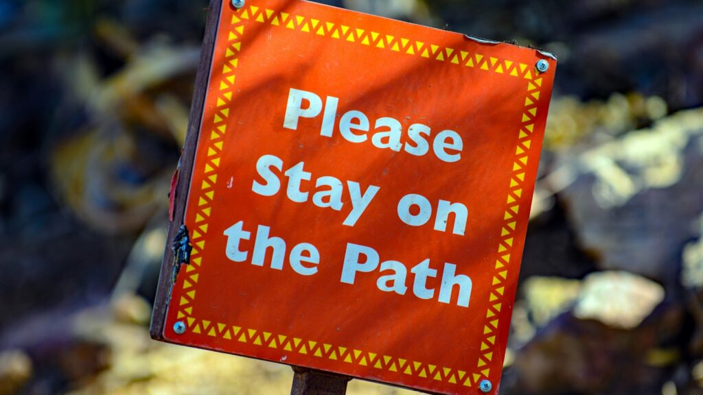 Please Stay on the Path” sign